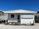 Single-story home with covered porch, awning, showcasing a functional and inviting outdoor living area at 3710 Gulf Of Mexico Dr # D19, Longboat Key, FL 34228