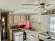 Functional kitchen with white cabinetry, gas range, and ample counter space at 3710 Gulf Of Mexico Dr # D19, Longboat Key, FL 34228