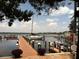 Serene view of a private dock with boats, showcasing waterfront living and recreational opportunities at 3710 Gulf Of Mexico Dr # D19, Longboat Key, FL 34228