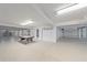 Spacious basement with air hockey table and garage access at 4136 Roberts Point Cir, Sarasota, FL 34242