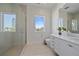 Modern bathroom with a walk-in shower, floating vanity, and bright natural light at 4136 Roberts Point Cir, Sarasota, FL 34242