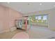 Pastel-themed bedroom with a colorful house-shaped bed and sliding glass doors leading to a balcony at 4136 Roberts Point Cir, Sarasota, FL 34242