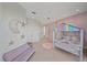 Spacious bedroom with a colorful bed, a small sofa, and ample closet space at 4136 Roberts Point Cir, Sarasota, FL 34242