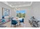 Bright dining area with a round table, blue velvet chairs, and modern chandelier at 4136 Roberts Point Cir, Sarasota, FL 34242