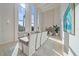 Sunlit dining room with large windows and modern table setting at 4136 Roberts Point Cir, Sarasota, FL 34242