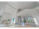 Two-story entryway with glass elevator and modern light fixtures at 4136 Roberts Point Cir, Sarasota, FL 34242