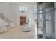 Spacious entryway with glass elevator and modern staircase at 4136 Roberts Point Cir, Sarasota, FL 34242