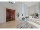 Bright entryway with high ceilings, glass table, and double doors at 4136 Roberts Point Cir, Sarasota, FL 34242
