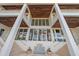 Luxury home exterior with staircase, fountain, and palm trees at 4136 Roberts Point Cir, Sarasota, FL 34242
