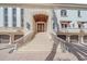 Impressive entrance with a grand staircase and double doors at 4136 Roberts Point Cir, Sarasota, FL 34242