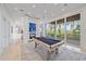 Game room with a pool table and access to outdoor patio at 4136 Roberts Point Cir, Sarasota, FL 34242