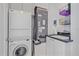 Laundry room with washer, dryer, utility sink, and ample storage at 4136 Roberts Point Cir, Sarasota, FL 34242