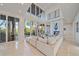Open living room showcasing a comfortable sectional sofa and access to a balcony at 4136 Roberts Point Cir, Sarasota, FL 34242