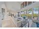 Bright living room with high ceilings, large windows, and stunning water views at 4136 Roberts Point Cir, Sarasota, FL 34242