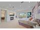 Main bedroom with fireplace and large windows at 4136 Roberts Point Cir, Sarasota, FL 34242