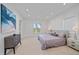 Bright main bedroom with a large bed, a dresser, and a window with garden views at 4136 Roberts Point Cir, Sarasota, FL 34242