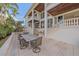 Elegant outdoor dining area adjacent to the house at 4136 Roberts Point Cir, Sarasota, FL 34242