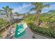Elevated view of a refreshing pool with lush landscaping and a relaxing patio at 4136 Roberts Point Cir, Sarasota, FL 34242