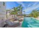 Relaxing poolside oasis with lounge chairs and outdoor shower at 4136 Roberts Point Cir, Sarasota, FL 34242
