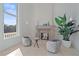 Cozy sitting area with fireplace and two comfortable armchairs, bathed in natural light at 4136 Roberts Point Cir, Sarasota, FL 34242