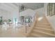 Elegant curved staircase with glass railings and modern design at 4136 Roberts Point Cir, Sarasota, FL 34242