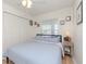 Cozy bedroom with queen-size bed and ceiling fan at 4207 Caddie E Dr # 202, Bradenton, FL 34203