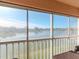 Enclosed balcony with serene lake view and screened windows at 4207 Caddie E Dr # 202, Bradenton, FL 34203