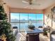 Enclosed balcony with lake view, wicker furniture and ceiling fan at 4207 Caddie E Dr # 202, Bradenton, FL 34203