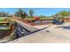 Wooden footbridge over a canal with golf cart and festive garland at 4207 Caddie E Dr # 202, Bradenton, FL 34203