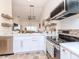 Modern white kitchen with stainless steel appliances and an island at 4207 Caddie E Dr # 202, Bradenton, FL 34203