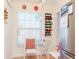 Cozy kitchen nook with white chairs and orange pillows at 4207 Caddie E Dr # 202, Bradenton, FL 34203