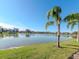 Scenic view of a tranquil lake with lush landscaping and homes at 4207 Caddie E Dr # 202, Bradenton, FL 34203