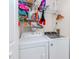 Bright laundry room with Whirlpool washer and dryer, and ample shelving at 4207 Caddie E Dr # 202, Bradenton, FL 34203