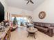 Cozy living room with brown leather couch and view to balcony at 4207 Caddie E Dr # 202, Bradenton, FL 34203