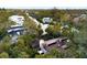 Aerial view of waterfront home with private dock and lush landscaping at 5112 Jungle Plum Rd, Sarasota, FL 34242