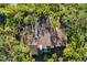 Aerial view of home nestled in tropical foliage at 5112 Jungle Plum Rd, Sarasota, FL 34242