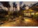 Brick patio, pond, and lush landscaping at dusk at 5112 Jungle Plum Rd, Sarasota, FL 34242