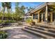 Brick patio steps lead to a home with pond and lush landscaping at 5112 Jungle Plum Rd, Sarasota, FL 34242