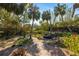 Landscaped backyard oasis with brick pathway and pond feature at 5112 Jungle Plum Rd, Sarasota, FL 34242