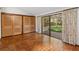 Bright bedroom with parquet flooring, built-in closets, and sliding glass doors at 5112 Jungle Plum Rd, Sarasota, FL 34242
