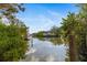 Scenic canal view with lush foliage and boats at 5112 Jungle Plum Rd, Sarasota, FL 34242
