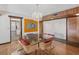 Elegant dining room with a glass table, chandelier, and hardwood floors at 5112 Jungle Plum Rd, Sarasota, FL 34242