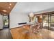 Modern dining room with glass table and hardwood floors, near the kitchen at 5112 Jungle Plum Rd, Sarasota, FL 34242