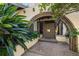 Inviting entryway with arched brick detail and a wood door at 5112 Jungle Plum Rd, Sarasota, FL 34242