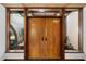 Interior view of double wood doors and windows with access to the courtyard at 5112 Jungle Plum Rd, Sarasota, FL 34242
