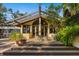 Mid-century modern home with a covered patio and lush landscaping at 5112 Jungle Plum Rd, Sarasota, FL 34242