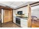 Retro kitchen with light wood cabinets, granite countertops, and tile floors at 5112 Jungle Plum Rd, Sarasota, FL 34242