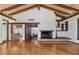 Spacious living room features a wood-burning fireplace and high, wood-beamed ceilings at 5112 Jungle Plum Rd, Sarasota, FL 34242