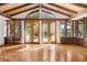 Bright living room with hardwood floors, vaulted ceiling, and access to patio at 5112 Jungle Plum Rd, Sarasota, FL 34242