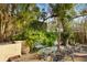 Relaxing patio with wrought iron furniture, surrounded by lush tropical landscaping at 5112 Jungle Plum Rd, Sarasota, FL 34242